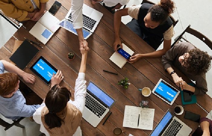 People at table with laptops, viewed from above